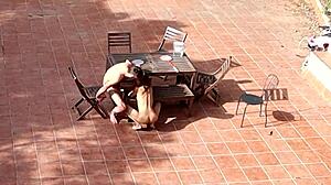 public couple plays games in garden courtyard outside