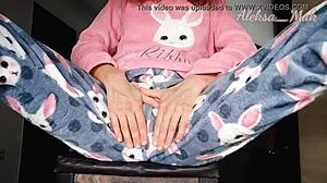 In pajamas playing with black vibrator