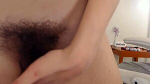 Watch this busty hottie finger her unshaved pussy on webcam!