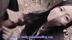 Asian Beauty Gives Handjob in Forest Hideout