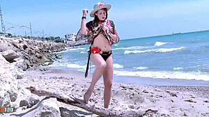 Petite 18+ redhead Emy Russo strips seductively on beach