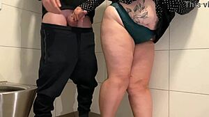 Juicy milf strokes cock in public toilet!
