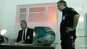 Before leaving the police station, the brunette endures a threesome with big cocks