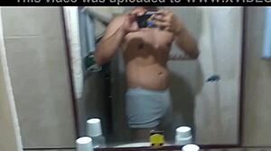 Athletic swinger poses in bathroom, dances striptease, masturbates to erection