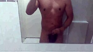 Athletic swinger poses in bathroom, dances striptease, masturbates to erection