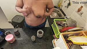 My girlfriend massaging her boobs with oil in the kitchen