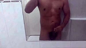 Athletic swinger poses in bathroom, dances striptease, masturbates to erection