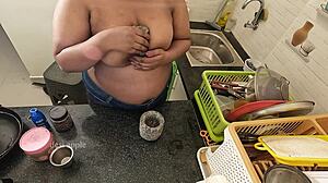 My girlfriend massaging her boobs with oil in the kitchen