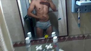 Athletic swinger poses in bathroom, dances striptease, masturbates to erection