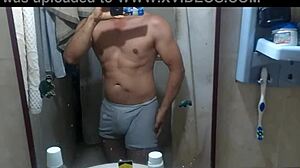 Athletic swinger poses in bathroom, dances striptease, masturbates to erection