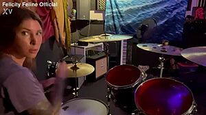 Felicity Feline drumming in her lockout with tattoos on display