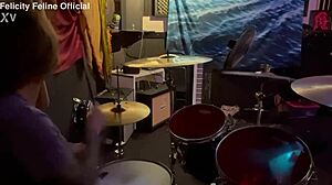 Felicity Feline drumming in her lockout with tattoos on display