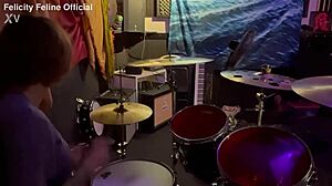 Felicity Feline drumming in her lockout with tattoos on display