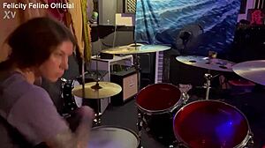 Felicity Feline drumming in her lockout with tattoos on display