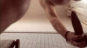 Playing with a big black dildo