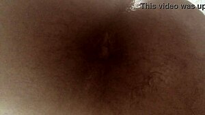 Playing with a big black dildo