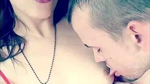 In the garage, a sexy couple engages in outdoor titty licking with glasses on, sucking and licking boobs topless