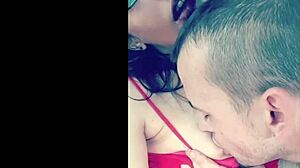 In the garage, a sexy couple engages in outdoor titty licking with glasses on, sucking and licking boobs topless