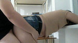 my girl wears a very old denim mini skirt at home