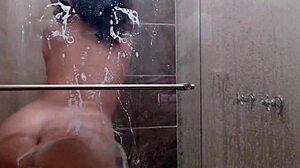 In the shower, she fingers her pussy, embracing her slutty nature with big tits.