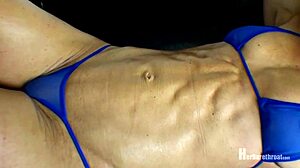 Bailey flexes her muscular body in a bikini and thong at the beach.