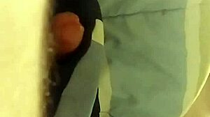 The slut kneels and delivers an intense blowjob to her partner in the dimly lit room, savoring every moment of the oral pleasure.