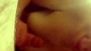 The slut kneels and delivers an intense blowjob to her partner in the dimly lit room, savoring every moment of the oral pleasure.