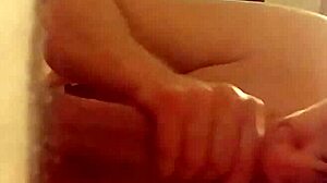 The slut kneels and delivers an intense blowjob to her partner in the dimly lit room, savoring every moment of the oral pleasure.