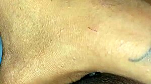 Ebony slut stuffs her pierced pussy with a pretty dildo in solo masturbation session