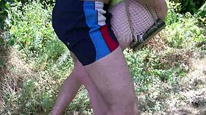 French brunette in bikini seduces three guys. Wild garden orgy unfolds with intense action.