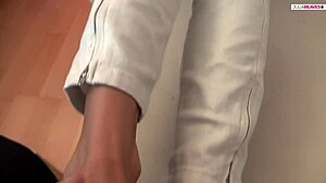 this sweet blonde girlfriend shows off her cute feet and has sex with them, leading to a big cock cumshot in close-up.