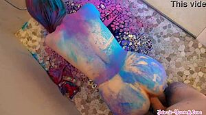 How does the petite 18+ teen get covered in colours and pleasured by her lover in the couple? Fucking bent over.