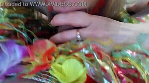 Wife gives blowjob to husband at Hawaiian party with kissing and licking.
