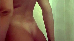 Latina touches her big tits while masturbating in shower.