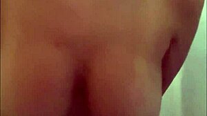 Latina touches her big tits while masturbating in shower.