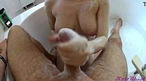 In the bath, busty babe cleans boyfriend's cock with big tits