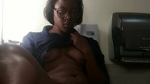 Ebony babe masturbates on bathroom counter, fingering her big ass close-up.