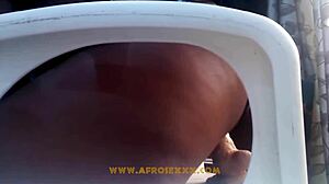 African Woman in Mini Skirt Uses Toy on Chair