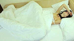 Sexy coed Rebecca masturbates under the blanket in lingerie.