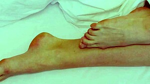 Sexy coed Rebecca masturbates under the blanket in lingerie.