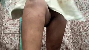 Dark-skinned woman with big tits shows off her body in the shower