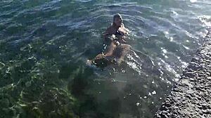 Milf playing with her candy body on public beach.