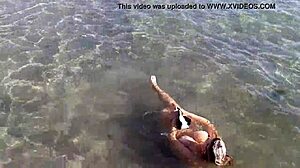 Milf playing with her candy body on public beach.