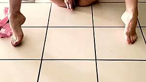 Young girl caresses herself and squirts hard in living room chaos.