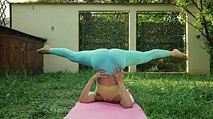 Sexy Blonde In Blue Leggings Does Yoga On Green Meadow, Showing Big Natural Tits