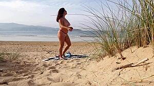 I filmed a curvy milf changing clothes and doing exercises on the beach