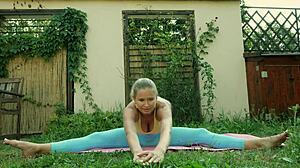 Sexy Blonde In Blue Leggings Does Yoga On Green Meadow, Showing Big Natural Tits