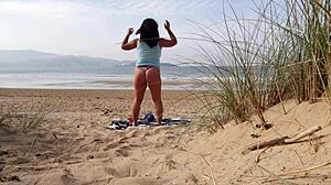 I filmed a curvy milf changing clothes and doing exercises on the beach