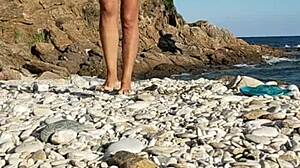 naked latina inserts pebbles on public beach!