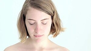 young babe subtly blows and pops her first balloon with a hint of blowjob